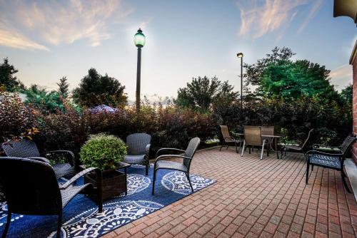 a group of chairs and tables on a patio at Hampton Inn Clifton Park in Clifton Park
