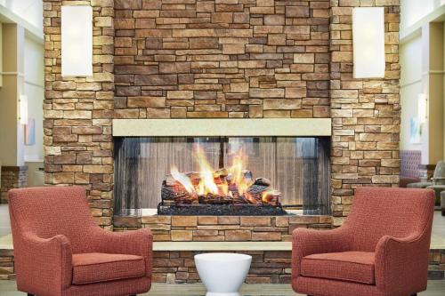 two chairs sitting in front of a fireplace at Homewood Suites by Hilton Columbus in Columbus