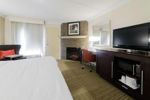 a hotel room with a bed and a fireplace at Hampton Inn Caryville-I-75/Cove Lake-State Park in Caryville