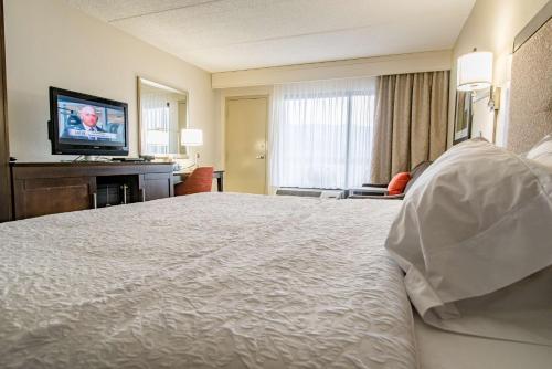 a hotel room with a bed and a flat screen tv at Hampton Inn Caryville-I-75/Cove Lake-State Park in Caryville