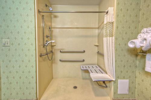 a bathroom with a shower with a bench in it at Hampton Inn Crossville in Crossville