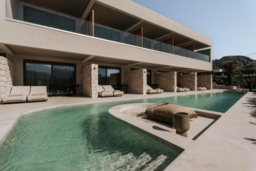 a house with a swimming pool next to a building at AMÉNTE Mindful Stay in Plakias