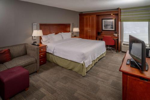 a hotel room with a bed and a television at Hampton Inn Charleston Downtown in Charleston