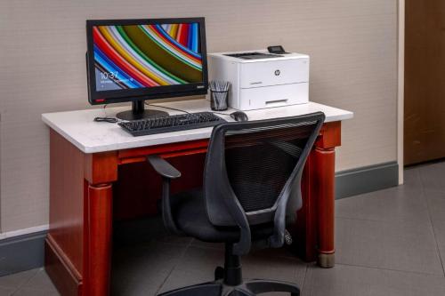 a desk with a computer monitor and a printer at Hampton Inn Charleston Downtown in Charleston