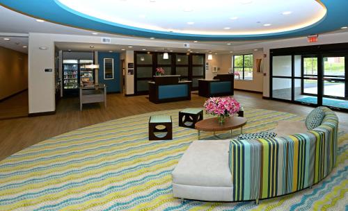 a large lobby with a couch and a table at Homewood Suites by Hilton Cincinnati/Mason in Mason
