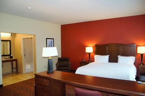 a hotel room with a bed and a desk with two lamps at Hampton Inn & Suites Cincinnati / Uptown - University Area in Cincinnati