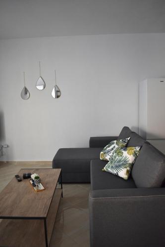 a living room with a couch and a coffee table at Charming House in Kástron
