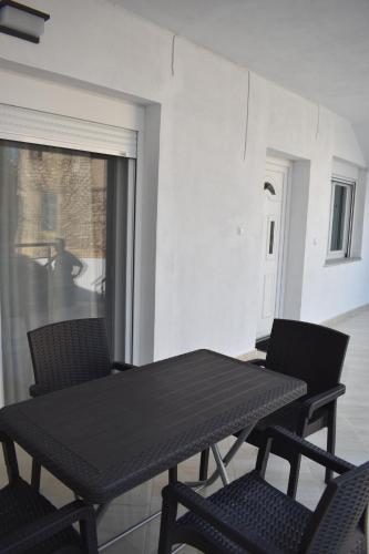 a black table and chairs in a room at Charming House in Kástron