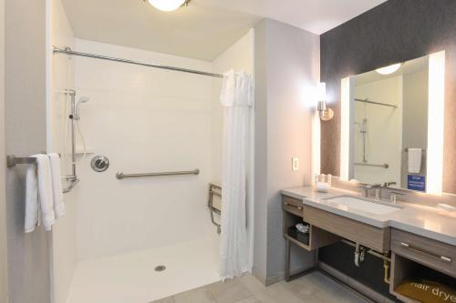 a bathroom with a shower and a sink at Homewood Suites Cincinnati Airport South-Florence in Florence