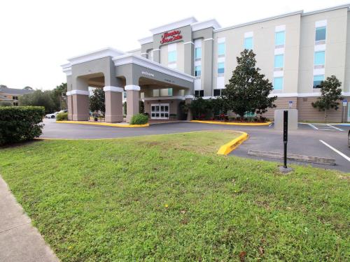 a large building with a parking lot in front of it at Hampton Inn & Suites Palm Coast in Flagler Beach
