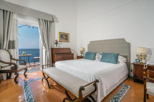 a bedroom with a bed and a view of the ocean at Albergo Miramare Positano in Positano