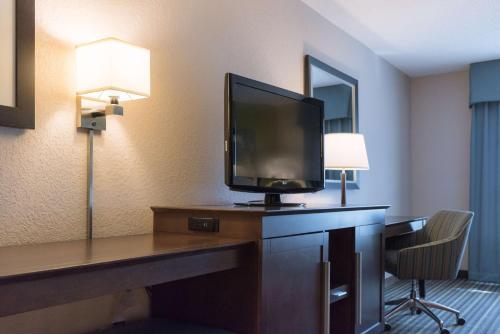 a hotel room with a desk with a television on it at Hampton Inn Brooksville Dade City in Ridge Manor