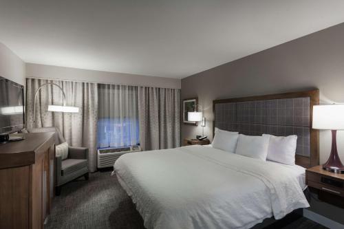 um quarto de hotel com uma cama e uma televisão em Hampton Inn & Suites Dallas DFW Airport North Grapevine em Grapevine