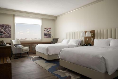 a hotel room with two beds and a window at DoubleTree by Hilton Hotel Dallas - Love Field in Dallas