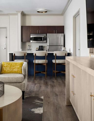 a living room with a couch and a kitchen at DoubleTree by Hilton Hotel Dallas - Love Field in Dallas