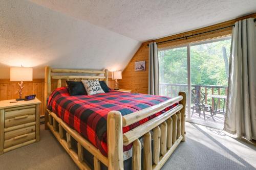 a bedroom with a bed and a balcony at Gaylord Cabin with Game Room and Lake Access! in Gaylord