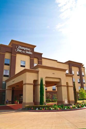 a hotel with a sign on the front of it at Hampton Inn & Suites Dallas-DeSoto in DeSoto