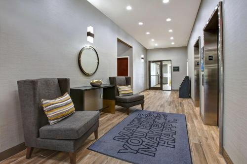 a hallway with a chair and a desk and a mirror at Hampton Inn & Suites Dallas-DeSoto in DeSoto