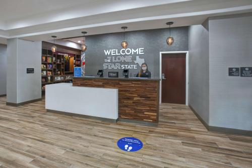 a store lobby with a welcome to the lone star shelter at Hampton Inn & Suites Dallas-DeSoto in DeSoto