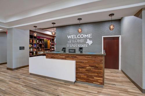 a lobby with a welcome to the lone star state sign on the wall at Hampton Inn & Suites Dallas-DeSoto in DeSoto