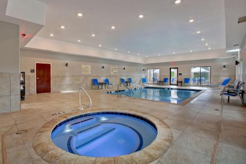 a large swimming pool with a blue tub in a room at Hampton Inn & Suites Dallas-DeSoto in DeSoto
