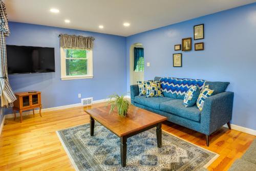 a living room with a blue couch and a table at Dog-Friendly Fitchburg Vacation Rental, Hike and Ski in Fitchburg