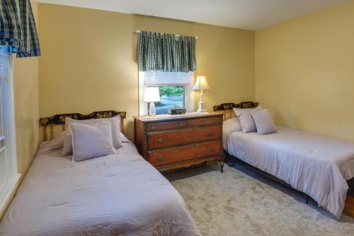 a bedroom with two beds and a dresser and a window at Dog-Friendly Fitchburg Vacation Rental, Hike and Ski in Fitchburg
