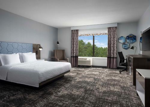 a hotel room with a bed and a window at Hampton Inn & Suites Dallas-DFW Airport Hurst in Hurst