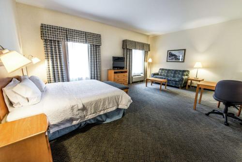 a hotel room with a bed and a desk and chair at Hampton Inn Dallas-Rockwall in Rockwall