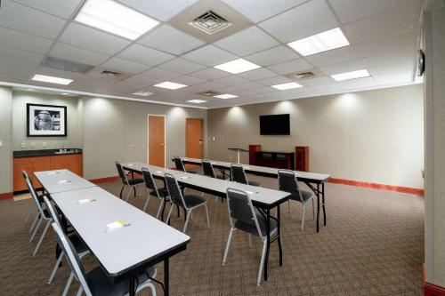 a conference room with tables and chairs and a tv at Hampton Inn Dublin in Newbern