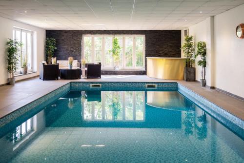 a swimming pool in a hotel room with blue water at Tickell Cottage in Kingsbridge
