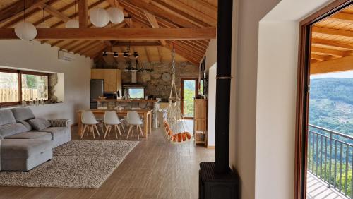 a living room and kitchen with a couch and a table at CASA DO SOL , Turismo Rural in Celorico de Basto