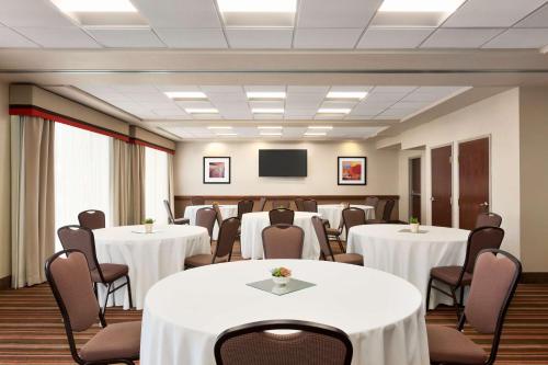 a conference room with tables and chairs and a tv at Hampton Inn Denver-West/Golden in Golden
