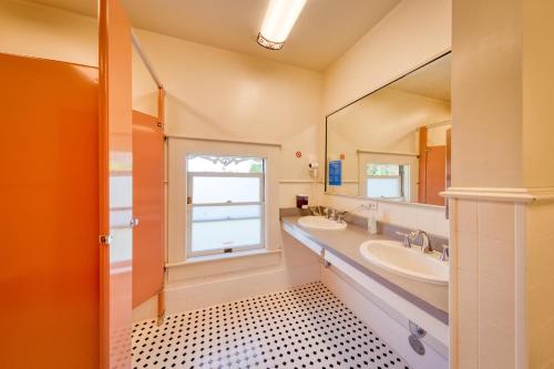 a bathroom with two sinks and a large mirror at HI Sacramento Hostel in Sacramento