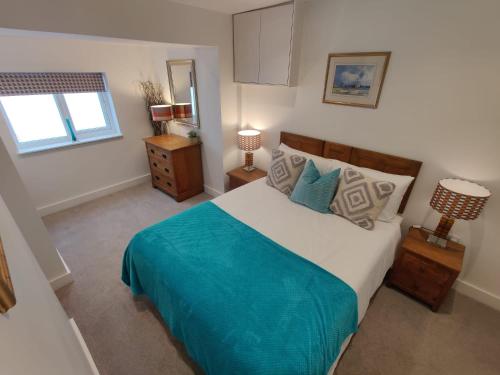 a bedroom with a large bed and a window at No 1 Penlee in Penzance