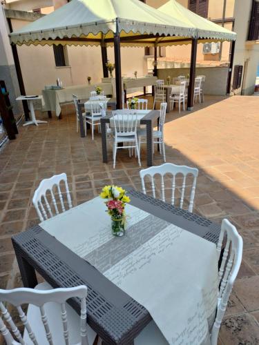 特罗佩阿La Locanda del Convento的庭院里摆放着桌椅和鲜花