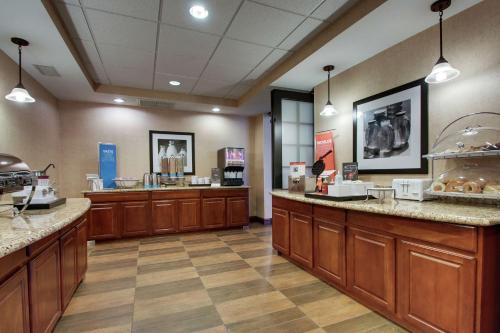 a lobby of a store with wooden cabinets and counters at Hampton Inn & Suites Denver Littleton in Littleton