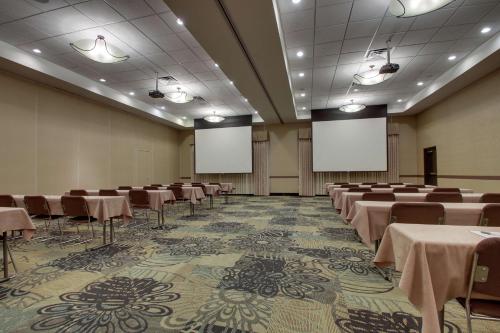 a conference room with tables and chairs and whiteboards at Hampton Inn & Suites Denver Littleton in Littleton