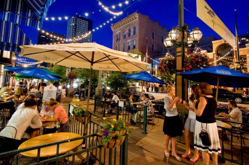 a group of people sitting at an outdoor restaurant at night at Hampton Inn Denver West Federal Center in Lakewood