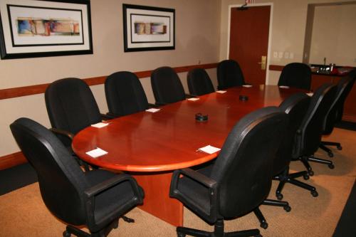 a conference room with a wooden table and black chairs at Hampton Inn Denver West Federal Center in Lakewood