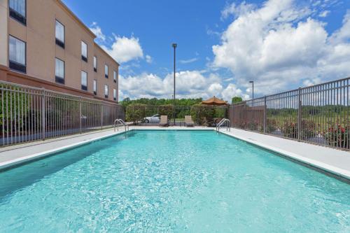 a swimming pool in front of a building at Hampton Inn Ozark in Ozark