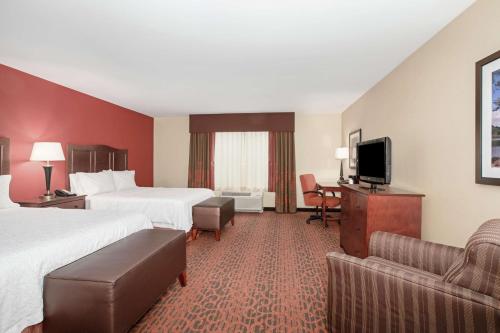 a hotel room with two beds and a flat screen tv at Hampton Inn and Suites Denver/South-RidgeGate in Lone Tree