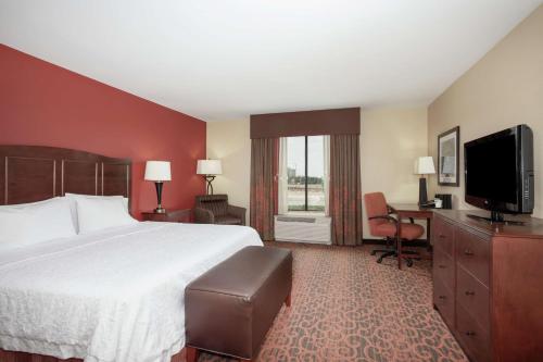 a hotel room with a bed and a flat screen tv at Hampton Inn and Suites Denver/South-RidgeGate in Lone Tree