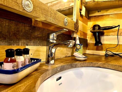 a bathroom sink with a faucet on a counter at The 2 Magpies, Hunza in Alīābād