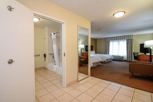 a hotel room with a bed and a bathroom at Hampton Inn & Suites Detroit/Chesterfield in Chesterfield