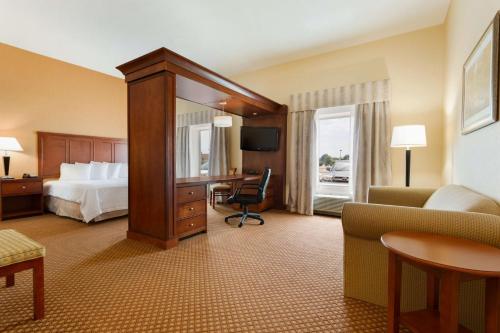 a hotel room with a bed and a desk at Hampton Inn & Suites Detroit/Chesterfield in Chesterfield
