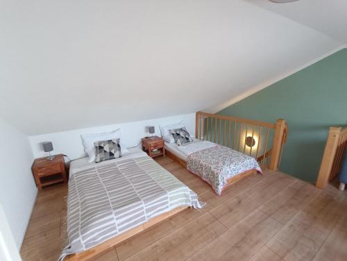 a bedroom with two beds and two night stands at FeWo Vineta in Barth