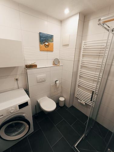 a small bathroom with a toilet and a shower at FeWo Vineta in Barth