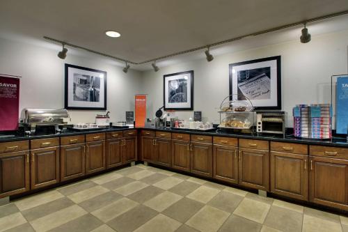a kitchen with wooden cabinets and a counter top at Hampton Inn DuBois in DuBois