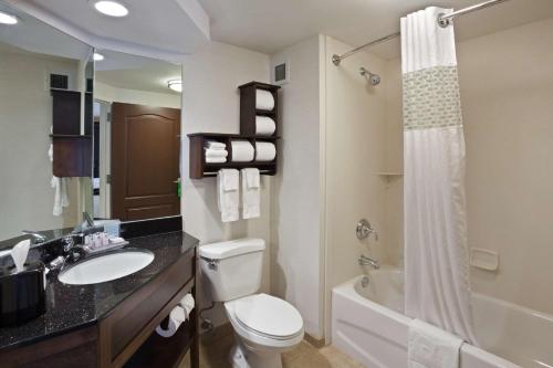 a bathroom with a toilet and a sink and a shower at Hampton Inn DuBois in DuBois